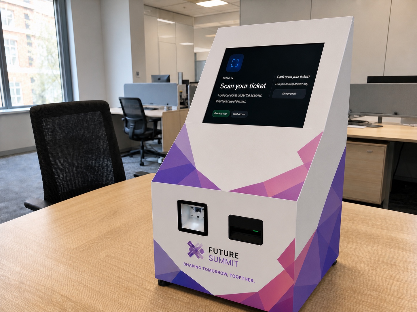 Branded tabletop self-registration kiosk with touchscreen, scanner, and badge printer on an office desk